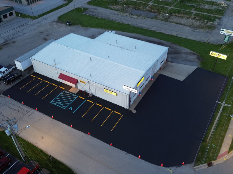 areal view of a commercial parking lot with new sealcoating and line striping